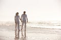 Couple, ocean and holding hands while walking on beach, travel and commitment with trust and bonding outdoor. Love, care Royalty Free Stock Photo
