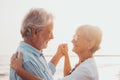 Couple of old mature people dancing together and having fun on the sand at the beach enjoying and living the moment. Portrait of Royalty Free Stock Photo