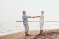 Couple of old mature people dancing together and having fun on the sand at the beach enjoying and living the moment. Portrait of Royalty Free Stock Photo