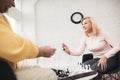 A couple of old people play chess at home. They play with delight and joy. Royalty Free Stock Photo