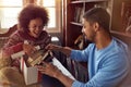 Couple opening present together while celebrating Christmas at h Royalty Free Stock Photo