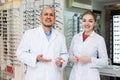 Couple ophthalmologists working in optics store