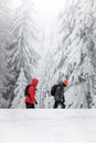 Couple in orange hiking in Gorce National Park in the winter Royalty Free Stock Photo