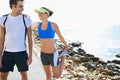 Couple, outdoor and stretching in beach, workout and fitness with smile, training and sunrise for run. Man, woman and Royalty Free Stock Photo