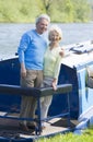 Couple outdoors on a boat smiling Royalty Free Stock Photo