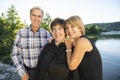 Couple outdoors with disabled person daughter by lake having good time