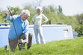 Couple outdoors by lake with boat Royalty Free Stock Photo