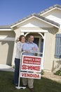 Couple Outside Home With Sold Sign Royalty Free Stock Photo