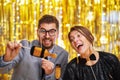 Couple over gold with photo booth accessories on party Royalty Free Stock Photo