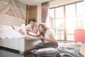 Couple packing suitcase on floor in room use tablet for search travel trip online pay by credit card Royalty Free Stock Photo
