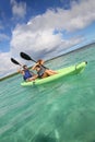 Couple paddling in a canoe in a crystal clear water Royalty Free Stock Photo