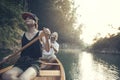 Couple paddling canoe on a forest lake