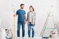 Couple with paint and instruments planning home repair Royalty Free Stock Photo