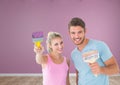 Couple with paintbrush and roller in room Royalty Free Stock Photo