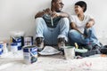 Couple painting house wall taking break Royalty Free Stock Photo