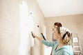 Couple Painting Wall With Paint Rollers Royalty Free Stock Photo