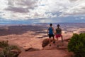 Couple with panoramic view on Buck Canyon seen from Mesa Arch near Moab, Canyonlands National Park, San Juan County, Utah, USA Royalty Free Stock Photo