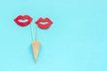 Couple paper lips props on stick in waffle cone on blue background. Concept lesbian love Creative Valentine`s Day Greeting card Royalty Free Stock Photo