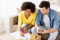 Couple with papers and calculator at home