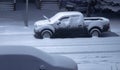 A couple of park pickup cars during a winter blizzard snow storm at night Royalty Free Stock Photo