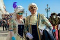 Couple of participants wear costumes and masks during carnival in Venice, Italy