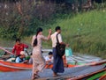 Couple passenger walk hand in hand from Myanmar traditional ferry across Yangon river on the morning