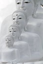 Couple peaceful white buddha statues sitting well alignment and decorating wonderful attractive mirror