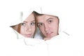 Couple peeping through hole in paper Royalty Free Stock Photo