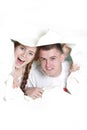 Couple peeping through hole in paper Royalty Free Stock Photo