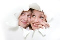 Couple peeping through hole in white paper Royalty Free Stock Photo