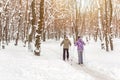 Couple of people enjoying cross-country skiing in city park or forest in winter. Family Sport outdoor activities in winter season Royalty Free Stock Photo