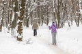 Couple of people enjoying cross-country skiing in city park or forest in winter. Family Sport outdoor activities in winter season Royalty Free Stock Photo