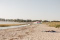 a couple of people laying on top of a sandy beach