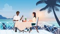 Couple people on love romance dating in outdoor cafe, sitting on tropical beach terrace Royalty Free Stock Photo