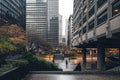 A couple of people are seen walking down a busy street surrounded by tall buildings, Brutalist architecture in a bustling city, AI Royalty Free Stock Photo