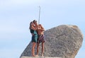 A couple of people shooting a selfie beach. do selfie has for some years a widespread practice Royalty Free Stock Photo