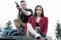 Couple of people sitting on the tank with the gun. Royalty Free Stock Photo