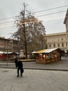 Couple of people walking through a bustling marketplace