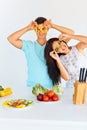 Couple with pepper slices smiling at the camera. Vegetables for