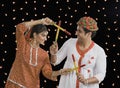 Couple performing Dandiya Raas on Navratri