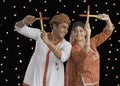 Couple performing Dandiya Raas on Navratri