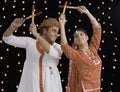 Couple performing Dandiya Raas on Navratri