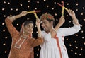 Couple performing Dandiya Raas on Navratri