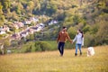 Couple With Pet Golden Retriever Dog Walking Along Path Across Field In Countryside Royalty Free Stock Photo