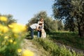 Couple with pet ,golden retriever dog, walking along path across field in countryside Royalty Free Stock Photo