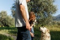 Couple with pet ,golden retriever dog, walking along path across field in countryside Royalty Free Stock Photo