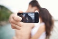 Couple, phone screen and selfie on beach, travel and love on honeymoon vacation. Happy man, woman and cellphone picture Royalty Free Stock Photo