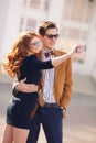 The couple is photographed with smartphone in the city Royalty Free Stock Photo