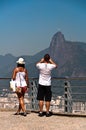 Couple photographing Christ the Redeemer in Rio de Janeiro, Brazil