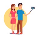 Couple photographing themselves on selfie stick